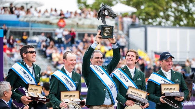 Chef d’Equipe Rodrigo Pessoa holds the trophy aloft as Team Ireland celebrate victory at the Longines FEI Jumping Nations Cup™ Final 2019 in Barcelona (ESP). (FEI/Lukasz Kowalski)